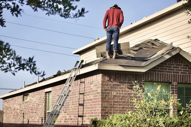 Professional roofer working on a residential roof in Joanna